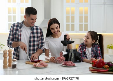 Happy Family Making Dinner Together In Kitchen, Woman Using Modern Meat Grinder While Man Cutting Onion