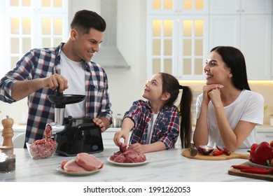 Happy Family Making Dinner Together In Kitchen, Daughter Helping Her Father While He Using Modern Meat Grinder