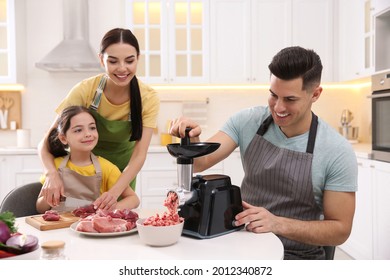 Happy Family Making Dinner Together In Kitchen, Father Using Modern Meat Grinder