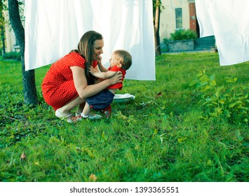 Happy Family Making Laundry Outside, Children Helping