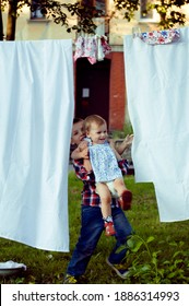 Happy Family Making Laundry Outside, Children Helping