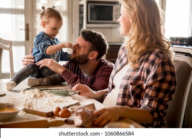 Happy Family Making Pasta In The Kitchen At Home