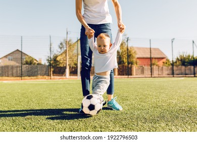 Happy Family, Mom And Child Playing Soccer On The Soccer Field