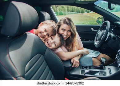 Happy Family, Mom Driving And Two Children Smiling, Two Sons In The Car Going On A Trip To Nature