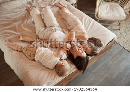 Similar – Little girl playing with boy over the bed