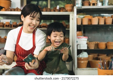 Happy family moment Mother teaching son how to painting mug cup ceramic workshop. Child creative activities and art. Kid playing  pottery workshop. Developing children's learning skills. - Powered by Shutterstock