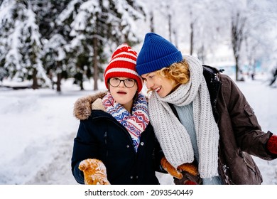 Happy Family Moments Concept. Mother With Child Boy Play In Winter Park.