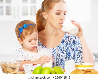 Happy Family Mother And Baby Daughter  Child Girl At Breakfast: Biscuits With Milk