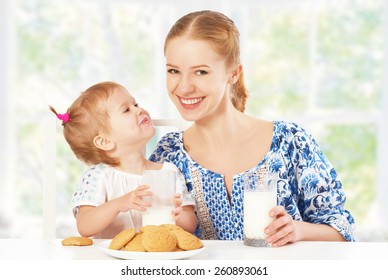 Happy Family Mother And Baby Daughter  Child Girl At Breakfast: Biscuits With Milk