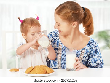 Happy Family Mother And Baby Daughter  Child Girl At Breakfast: Biscuits With Milk