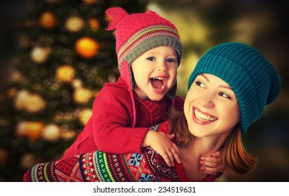 Happy Family Mother And Baby Little Daughter Playing In The Winter For The Christmas Holidays