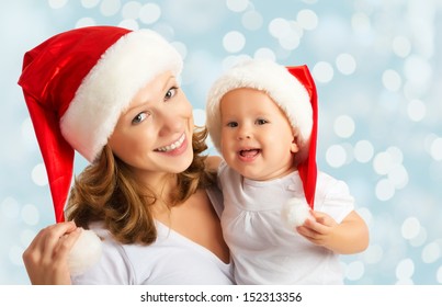 Happy Family Mother And Baby In Red Christmas Hats