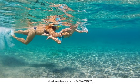 Happy Family - Mother With Baby Son Dive Underwater With Fun In Sea Pool. Healthy Lifestyle, Active Parent, People Water Sport Outdoor Adventure, Swimming Lessons On Beach Summer Holidays With Child