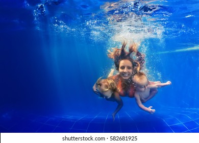 Happy Family - Mother, Baby Son, Daughter Swim And Dive In Pool With Fun - Jump Deep Down Underwater With Splashes.