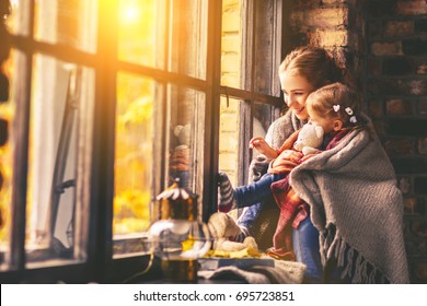 Happy Family Mother And Baby Son In Autumn Window
