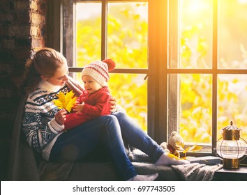 Happy Family Mother And Baby Son In Autumn Window
