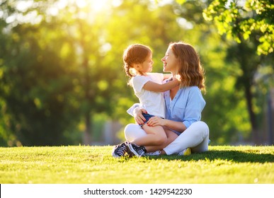 Happy Family Mother And Child Daughter In Nature Park In Summer On Green Grass
