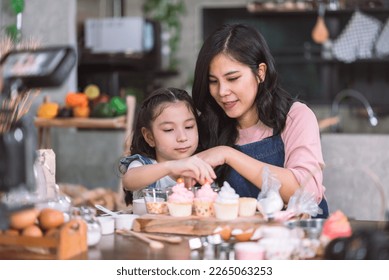 Happy family, Mother and child daughter enjoy making cupcake and bakery at home. - Powered by Shutterstock