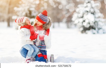 Happy Family Mother And Child Daughter On A Winter Walk Outdoors Drinking Tea