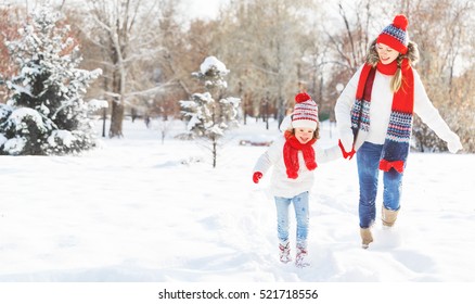 Happy Family Mother And Child Daughter Having Fun, Playing At Winter Walk Outdoors