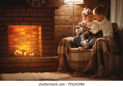 happy family mother and child daughter read a book on winter autumn evening near fireplace
 - Powered by Shutterstock