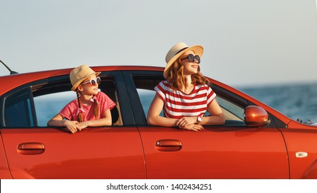 Happy  Family Mother And Child Girl Goes To Summer Travel Trip In The Car
