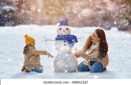 Happy Family! Mother And Child Girl On A Winter Walk In Nature.