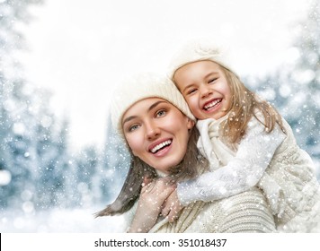 Happy Family! Mother And Child Girl On A Winter Walk In Nature.