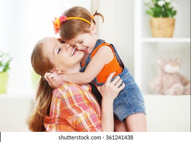 Happy Family Mother And Child Girl Daughter Playing  Laughing And Hugging At Home