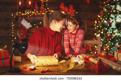 a happy family mother and child pack Christmas gifts - Powered by Shutterstock