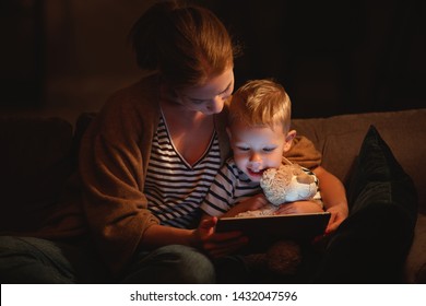 happy family mother and child son with  tablet in evening before bed
 - Powered by Shutterstock