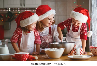happy family mother and children son and daughter bake cookies for Christmas