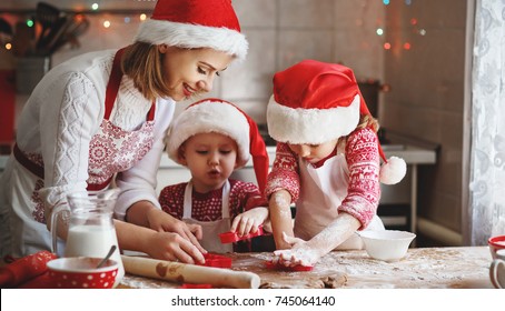 Happy Family Mother And Children Son And Daughter Bake Cookies For Christmas
