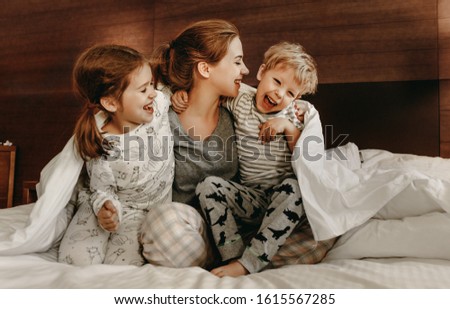 Similar – Top view of happy children having breakfast in the bed with their mother in a relaxed morning