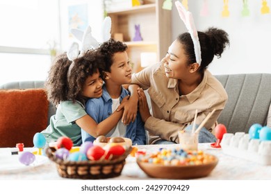 Happy family : mother and cute kids wearing bunny ears hugging looking each other celebration Easter at home - Powered by Shutterstock