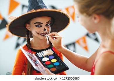 happy family mother   daughter getting ready for halloween make make  up