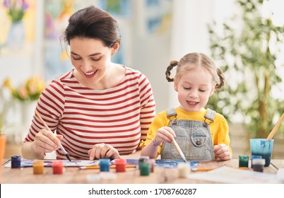 Happy Family. Mother And Daughter Painting Together. Adult Woman Helping To Child Girl.                                