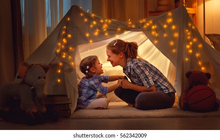 happy family mother and daughter playing at home in a tent  - Shutterstock ID 562342009