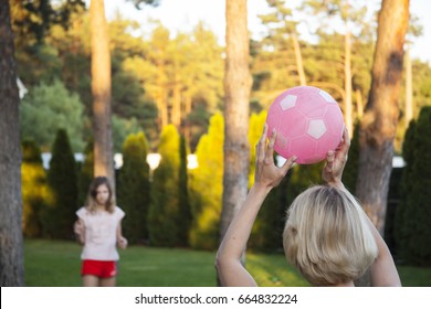 Happy Family Mother And Daughter Playing Volleyball. Ball Game In The Backyard