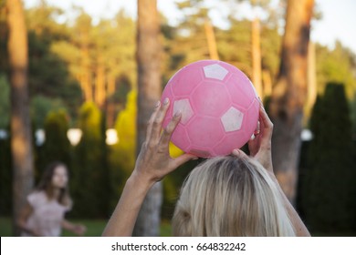 Happy Family Mother And Daughter Playing Volleyball. Ball Game In The Backyard