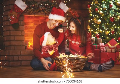 happy family mother father and baby at christmas tree  at home - Powered by Shutterstock