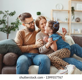 Happy Family Mother Father And Child Daughter Laughing And Havig Fun At Home  
