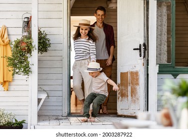 happy family: mother father and child son run out of country house, laughing and playing in the summer at the dacha  