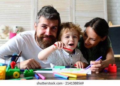 Happy family mother, father and child drawing. Happy family with children on weekend. Young parents and their child are very happy at home. Kids early arts and crafts education, drawing.