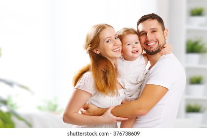 Happy Family Mother, Father,  Child Daughter At Home