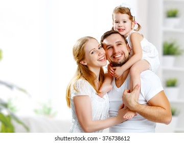 Happy Family Mother, Father,  Child Daughter At Home