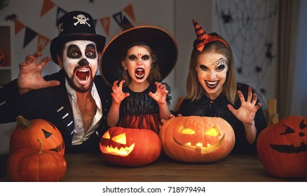 happy family mother father and child daughter  in costumes and makeup on a celebration of Halloween - Shutterstock ID 718979494