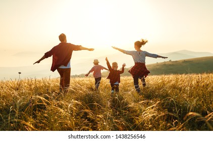 Happy family: mother, father, children son and  daughter on nature  on sunset
 - Powered by Shutterstock