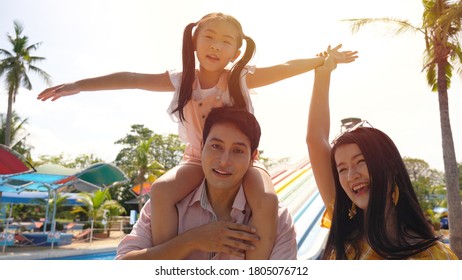 A Happy Family Of Mother, Father And Children, Daughter, Having Fun On Vacation At A Water Park