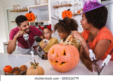 Happy Family Mother Father And Children Prepare For Halloween Using Digital Tablet For Video Call.